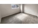 Simple bedroom with grey carpet and white brick wall at 6800 E Tennessee Ave # 232, Denver, CO 80224