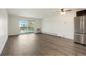 Spacious living room with hardwood floors and access to balcony at 725 S Clinton St # 7B, Denver, CO 80247