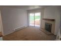 Bright living room featuring a fireplace and access to a private patio at 14794 E 2Nd Ave # 111F, Aurora, CO 80011