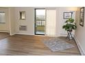 Bright living room with wood-look floors, sliding door to balcony, and ample natural light at 13890 E Marina Dr # 612, Aurora, CO 80014