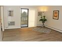 Bright living room with wood-look floors, sliding door to balcony, and ample natural light at 13890 E Marina Dr # 612, Aurora, CO 80014