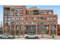 Multi-story brick building with commercial spaces on the ground floor and residential units above at 1499 Blake St # 1A & 1B, Denver, CO 80202