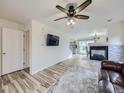 Living room with tile floors, fireplace and a view into the dining area at 9765 Hannibal Ct, Commerce City, CO 80022