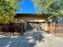 Two car attached garage with wood fence at 1076 Rosemary St, Denver, CO 80230