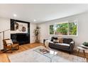 Bright living room with a modern fireplace and large window at 210 E Graves Ave, Centennial, CO 80121