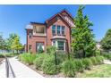 Brick townhome with a walkway and lush landscaping at 1379 Charles Dr # 5, Longmont, CO 80503