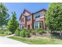 Attractive brick townhome with landscaping and black fence at 1379 Charles Dr # 5, Longmont, CO 80503