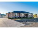 House exterior showcasing front yard and driveway at 12535 Valentia St, Brighton, CO 80602