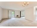 Bright living room with access to balcony and view to neighboring building at 13890 E Marina Dr # 111, Aurora, CO 80014