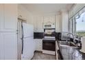 Kitchen features white cabinets, granite countertops, and stainless steel appliances at 1155 N Ash St # 1504, Denver, CO 80220