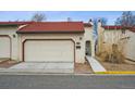 Front view of townhome with red tile roof and garage at 1307 Bosque St, Broomfield, CO 80020