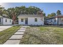 Newly built white house with a gray door and walkway at 2051 S King St, Denver, CO 80219