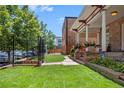 Landscaped front yard of a charming stone home with a wrought iron fence at 1563 N Lafayette St, Denver, CO 80218