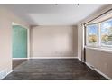 Living room with hardwood floors and a large bay window at 7527 Newland St, Arvada, CO 80003