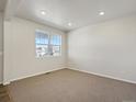 Spacious living room with large window and neutral color palette at 9162 Quintero St, Commerce City, CO 80022