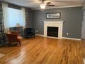 Living room featuring hardwood floors, fireplace, and comfortable seating at 542 E Caley Dr, Centennial, CO 80121