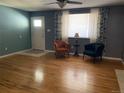 Hardwood floor living room with two armchairs and a view to the front door at 542 E Caley Dr, Centennial, CO 80121