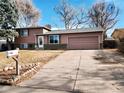 House exterior showcasing a two-car garage and well-maintained lawn at 2888 S Olathe Way, Aurora, CO 80013