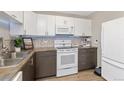 Modern kitchen with updated appliances and a corner sink at 660 S Alton Way # 4A, Denver, CO 80247