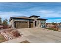 Two-story house with attached garage and landscaping at 7899 S Jackson Gap St, Aurora, CO 80016