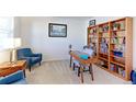 Home office features a desk, built-in shelves, and hardwood floors at 9299 Rifle St, Commerce City, CO 80022
