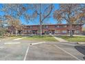 Brick townhouses with a well-maintained lawn and parking area at 3744 Miller Ct, Wheat Ridge, CO 80033