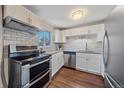Modern kitchen with stainless steel appliances and white shaker cabinets at 3744 Miller Ct, Wheat Ridge, CO 80033