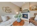 Living room fireplace with neutral wall decor at 25 Canongate Ln, Highlands Ranch, CO 80130