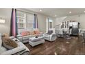 Bright living room with white couches, coffee table, and hardwood floors at 6251 N Malaya St, Aurora, CO 80019