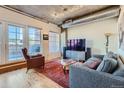 Living room with hardwood floors, large windows, and city views at 1499 Blake St # 5I, Denver, CO 80202