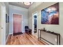 Bright entryway with hardwood floors, coat closet, and bench at 1499 Blake St # 5I, Denver, CO 80202