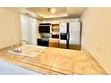 Clean and efficient kitchen with modern appliances and tile countertops at 16001 E Alaska Pl # 7, Aurora, CO 80017