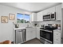 Modern kitchen with stainless steel appliances and white cabinets at 1845 W 46Th Ave, Denver, CO 80211