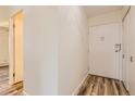 Simple hallway with light walls and wood flooring at 585 S Alton Way # 2C, Denver, CO 80247