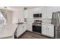 Modern kitchen with white cabinets and stainless steel appliances at 2855 Rock Creek Cir # 301, Superior, CO 80027