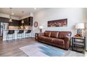 Living room with brown leather couch and city view at 20 Wilcox St # 621, Castle Rock, CO 80104