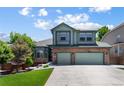 Two-story house with a three-car garage and landscaped yard at 9772 Clairton Pl, Highlands Ranch, CO 80126