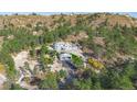 Hilltop castle-style home with a large, landscaped yard at 5380 N Lariat Dr, Castle Rock, CO 80108