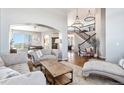 Spacious living room with hardwood floors, two sofas, and a view of the staircase at 9508 E 147Th Ave, Brighton, CO 80602