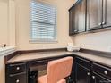 Functional home office space with built-in cabinetry and a printer at 5138 Chicory Cir, Brighton, CO 80601