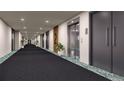Clean and modern hallway with elevator access and carpeted floors at 12983 W Ida Ave # 216, Littleton, CO 80127