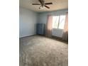 Bright bedroom with neutral carpeting and a ceiling fan at 3800 Converse Rd, Bennett, CO 80102