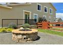 Fire pit and fenced-in backyard with a wooden gate at 14595 Vancouver Pl, Parker, CO 80134
