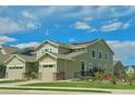 Two-story house with solar panels, landscaped yard, and attached garage at 14595 Vancouver Pl, Parker, CO 80134