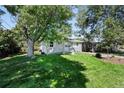 Gray ranch home with mature tree and well-maintained lawn at 307 Sheader Ave, Lafayette, CO 80026