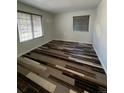 Bedroom with hardwood flooring and two windows at 2604 S Dunkirk Ct, Aurora, CO 80013