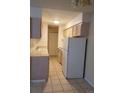 Full kitchen view with white appliances and light wood cabinets at 7755 E Quincy Ave # 101, Denver, CO 80237