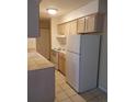 Full kitchen view with white appliances and light wood cabinets at 7755 E Quincy Ave # 101, Denver, CO 80237