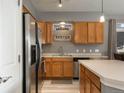 Kitchen with wood cabinets and stainless steel refrigerator at 10184 Park Meadows Dr # 1112, Lone Tree, CO 80124