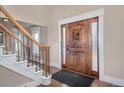 Bright entryway with hardwood floors, staircase, and wooden door at 1490 Saint Andrews Dr, Broomfield, CO 80020